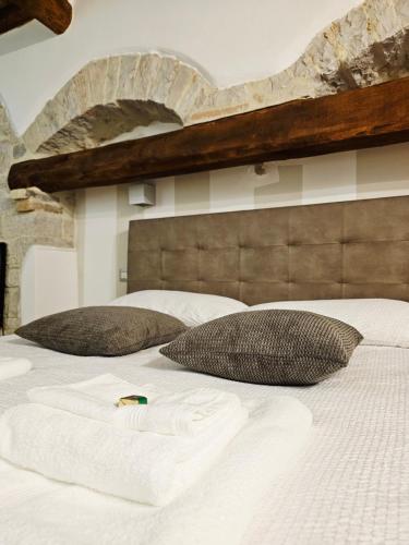 a large white bed with two pillows on it at Casa Vacanze Todi in Todi