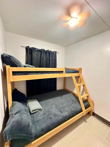 a bedroom with two bunk beds and a ceiling at Maria Staycation House in Davao City