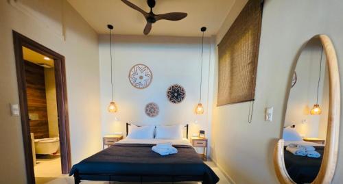 a bedroom with a bed and a large mirror at Rastoni Sea View Studio with Shared Pool in Melíssion