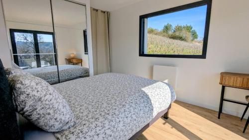 a bedroom with a bed and a window at Savigny Vineyard View & SPA in Savigny-lès-Beaune