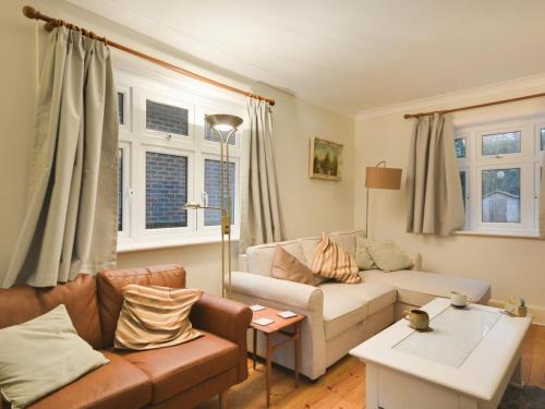a living room with a couch and a table at 4 Bed in Swanage oc-dc046 in Studland