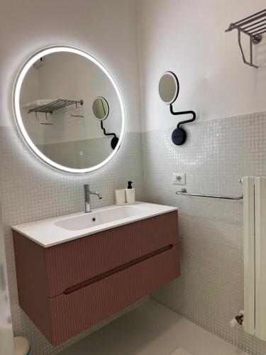 a bathroom with a sink and a mirror at Appartamento Rosa Rosa' in Porto SantʼElpidio