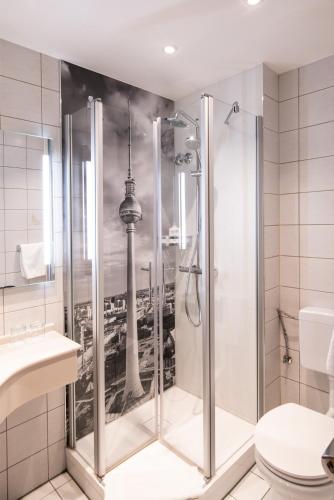 a bathroom with a shower with a picture of the shard at Hotel Schöneberg in Berlin