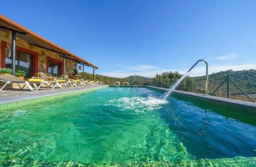 a swimming pool with a fountain in the water at Bravaholidays-625-Silence in Terra Brava