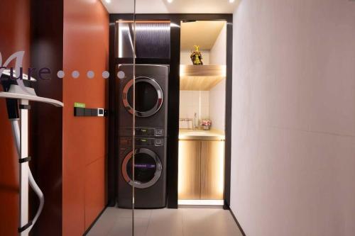 a kitchen with a washer and dryer in a room at Mercure Beijing Tiananmen Square Qianmen Street in Beijing
