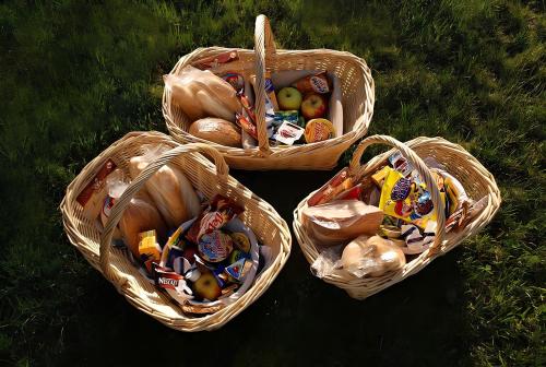 three baskets filled with trash sitting on the grass at Erato Apartments in Firostefani