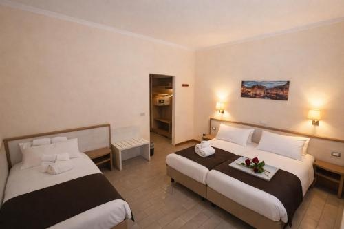 a hotel room with two beds in a room at Hotel Adler in Milan