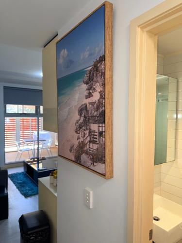 a picture of a beach on a wall in a room at The Padbury Suites 1-Premium City Apartment in Karratha