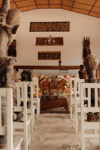 a living room with white chairs and a couch at Rwanda African Art Museum in Nyabisindu