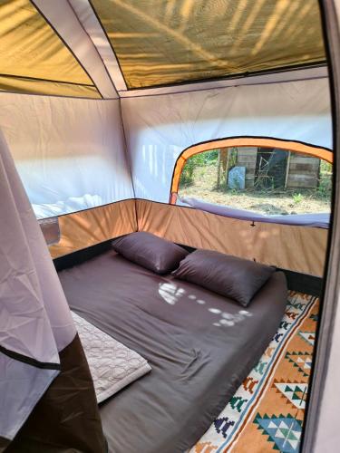 a bed in the inside of a tent at KhaoSok Farmstay in Khao Sok National Park