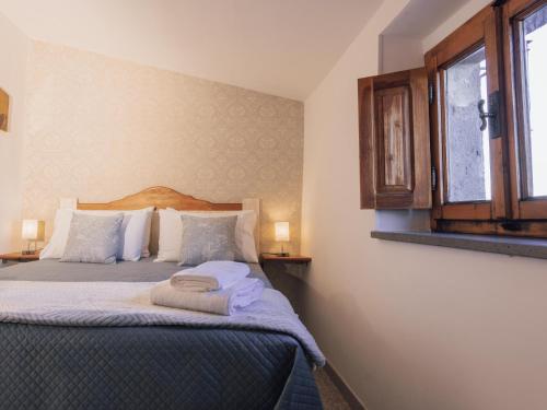 a bedroom with a bed with two towels on it at La casetta di Mercatello in Bagnoregio