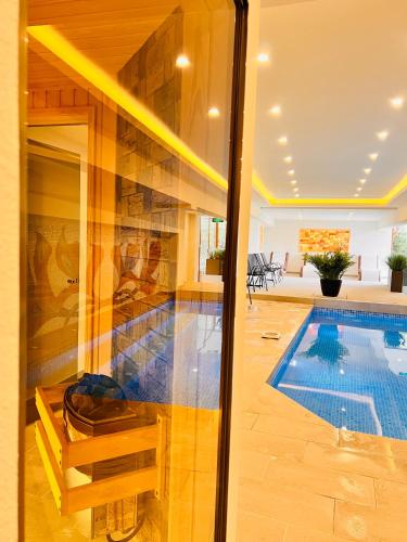 a villa with a swimming pool and a house at ArdoVel Park Hotel in Velingrad