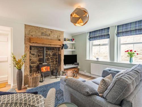 a living room with two couches and a fireplace at 2 Bed in Morpeth oc-87902 in Rothbury