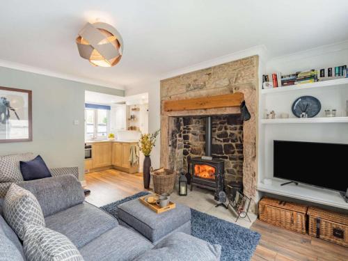 a living room with a couch and a fireplace at 2 Bed in Morpeth oc-87902 in Rothbury