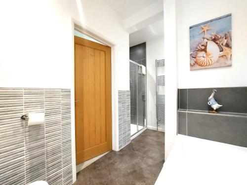 a bathroom with a walk in shower and a toilet at Meadow View Apartments are 2 and 3 bedroomed with private parking in Newquay