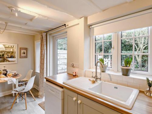 a kitchen with a sink and a dining room with a table at 2 Bed in York oc-90906 in Sheriff Hutton