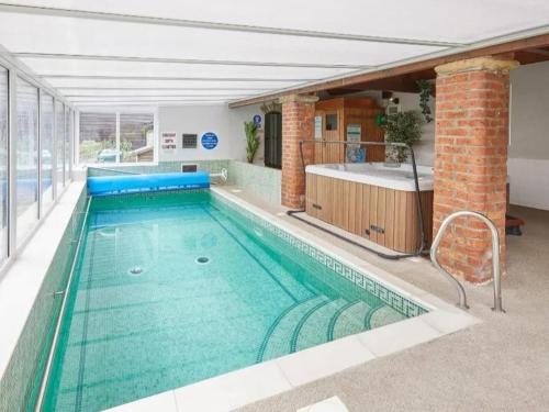a swimming pool with green water in a building at 2 Bed in Pickering oc-88957 in Newton