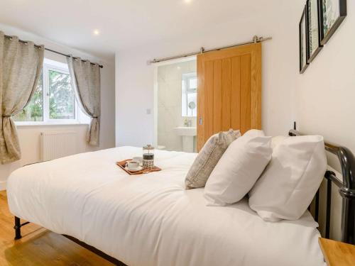 a bedroom with a white bed with a tray on it at 2 Bed in Hull oc-89596 in Ryhill