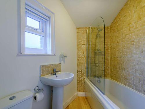 a bathroom with a sink and a glass shower at 1 Bed in Holmfirth oc-91106 in Cartworth