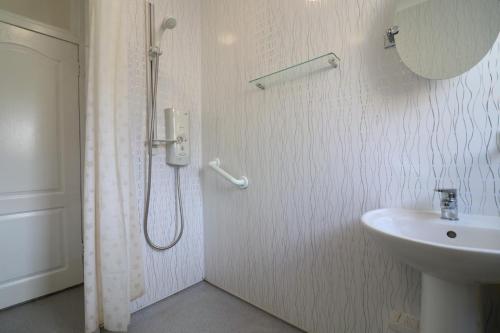 a bathroom with a shower and a sink at Signature - Bueno View - Greenock in Greenock