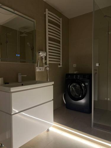 a bathroom with a washing machine and a sink at Gonta house in Skhidnitsa