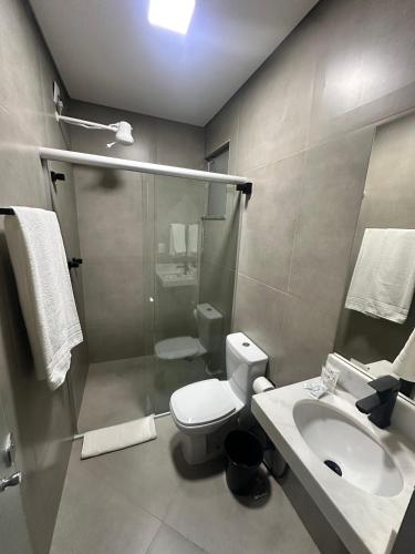 a bathroom with a shower and a toilet and a sink at B Hotel 888 hotéis - Próximo a Rodoviária e Praça Sete in Belo Horizonte