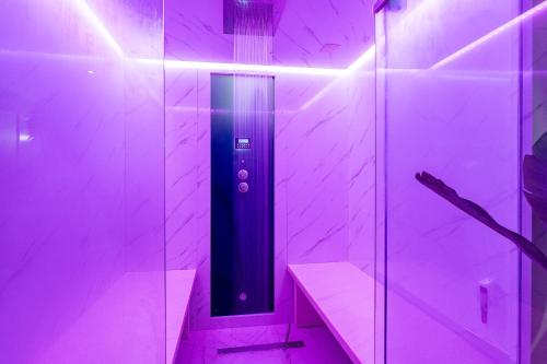 a walk in shower with purple lights in a bathroom at Apartments Tomo in Sukošan
