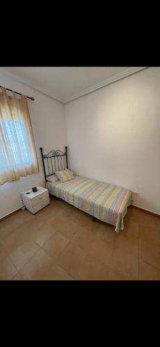 a bedroom with a bed and a window at Casa Enrique in Alicante