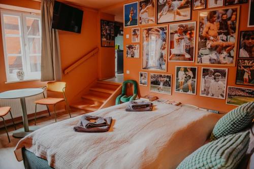a bedroom with a bed with pictures on the wall at sleepArt match point in Celle