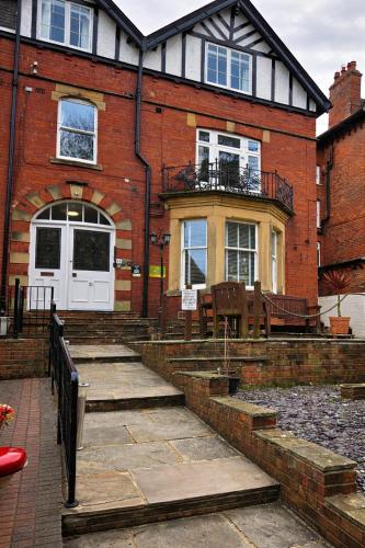 a brick house with stairs in front of it at Pannett View in Whitby