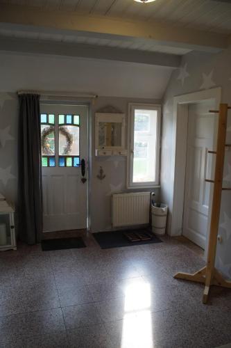 a room with a door and a toilet and a window at Kreativ-Kate in Kranenburg