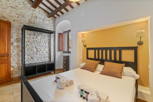 a bedroom with a large bed in a room at Casa con patio, piedra y luz natural in Sant Pere de Ribes