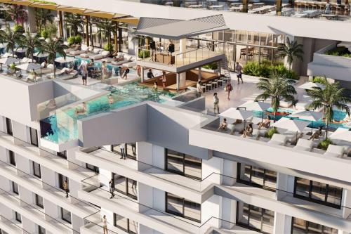 an aerial view of a building with a pool at Hard Rock Hotel Malta in St. Julianʼs
