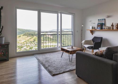 a living room with a couch and a table at Moselsteig Lodge in Starkenburg