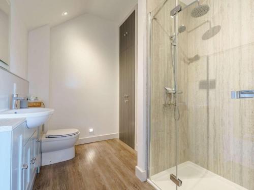 a bathroom with a shower and a toilet and a sink at 3 Bed in Malton oc-75899 in Amotherby