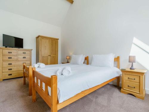 a bedroom with a bed and a dresser and a tv at 3 Bed in Malton oc-75899 in Amotherby