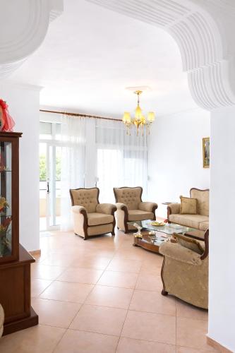 a living room with couches and a table at EUREKA in Vlorë