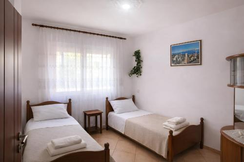a room with two beds and a window at EUREKA in Vlorë