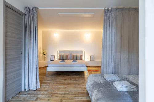 a bedroom with a large bed in a room at ApartVilla Trieste in Trieste