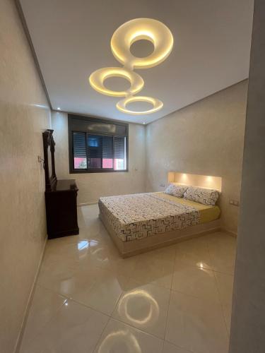 a bedroom with a bed and a ceiling with a chandelier at House with beautiful partial sea view in Mirleft