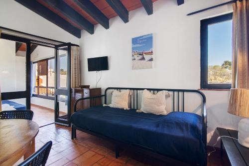 a bedroom with a bed with a blue comforter at Pedras Del Rei 8 in São Pedro