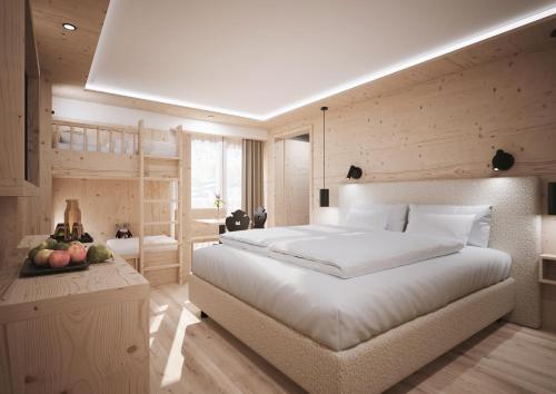 a bedroom with a large white bed and wooden walls at Gorfion Familienhotel in Malbun