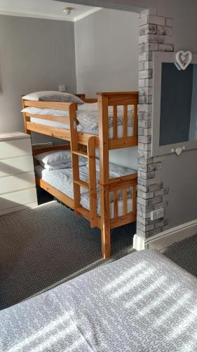 a room with two bunk beds and a chalkboard at Llanryan Guest House in Blackpool