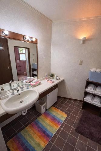 a bathroom with a sink and a large mirror at 478 retreat in Yoron