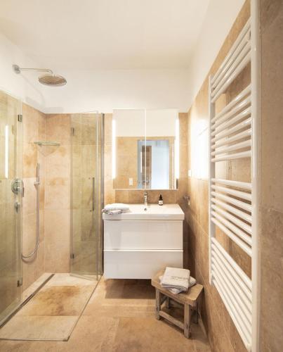 a bathroom with a sink and a shower at Seehaus Verena in Weissensee