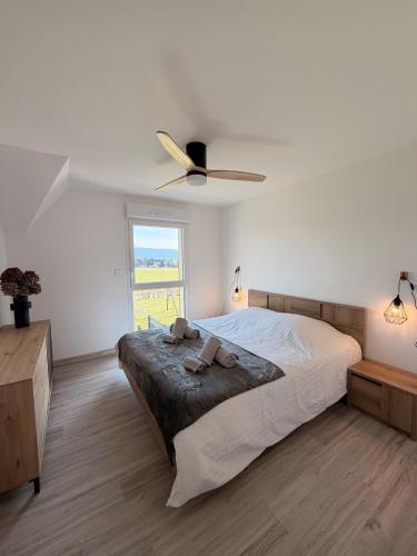 a bedroom with a bed and a ceiling fan at Maison La Bullette à 10 min de Pontarlier in Bulle