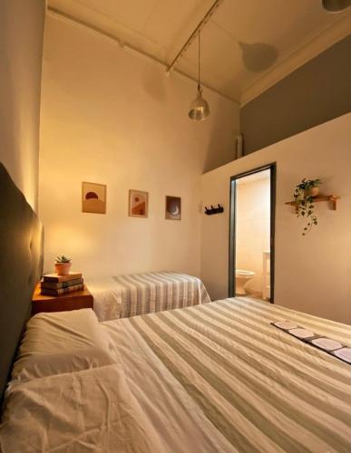 a bedroom with a bed and a window at ViaVia Buenos Aires GuestHouse in Buenos Aires