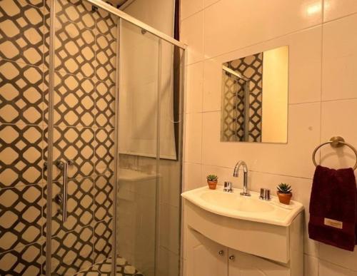 a bathroom with a sink and a shower at ViaVia Buenos Aires GuestHouse in Buenos Aires