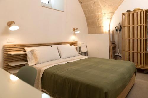 a bedroom with a bed and a table in a room at Suite Bobo in Monopoli