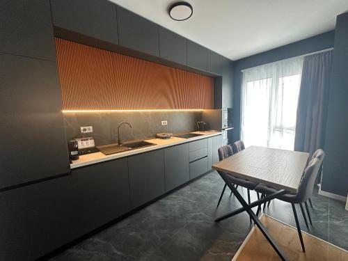 a kitchen with a table and a sink at LaRa Apartament in Timişoara